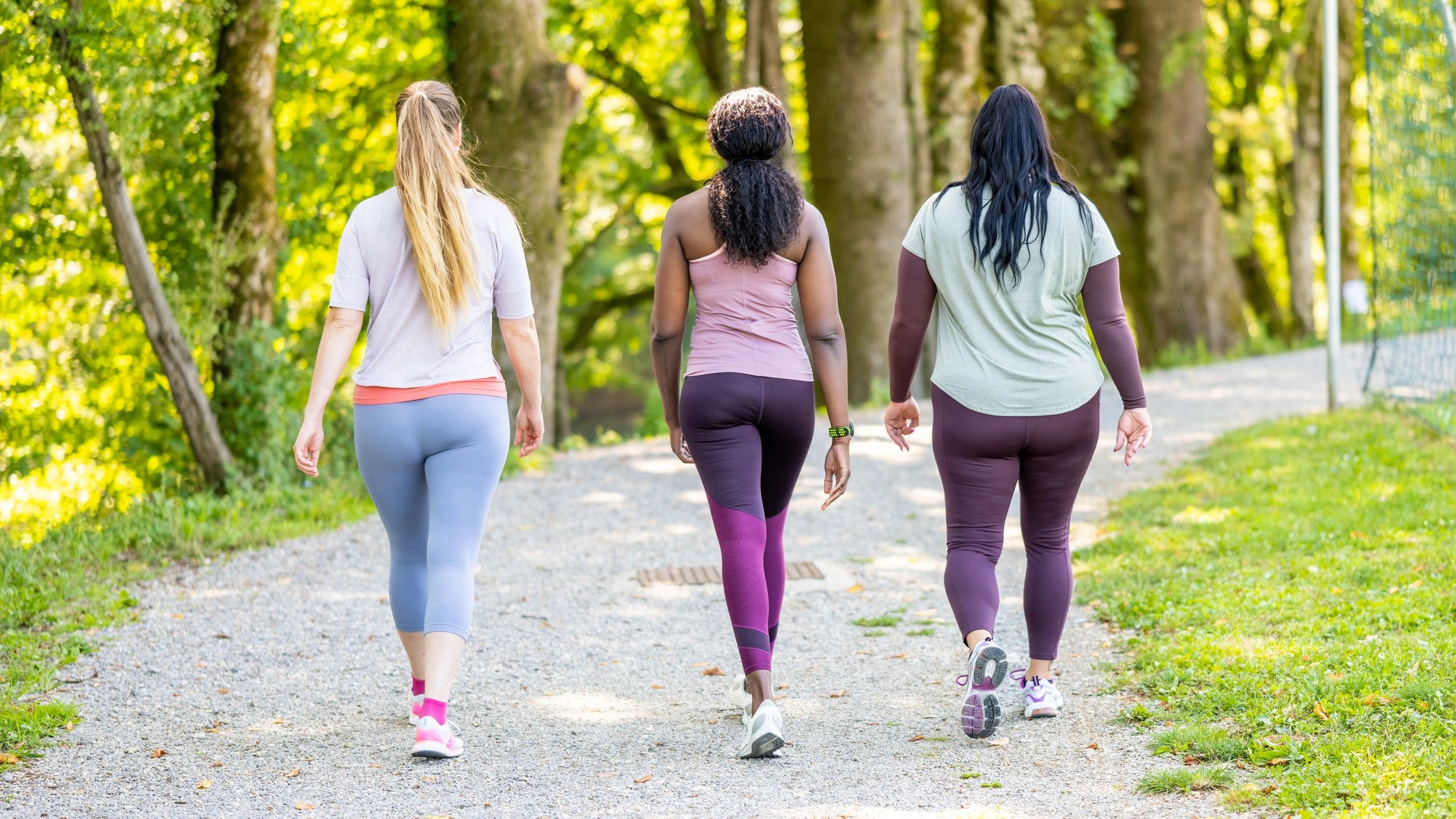 Women in sportswear walking together in a park
