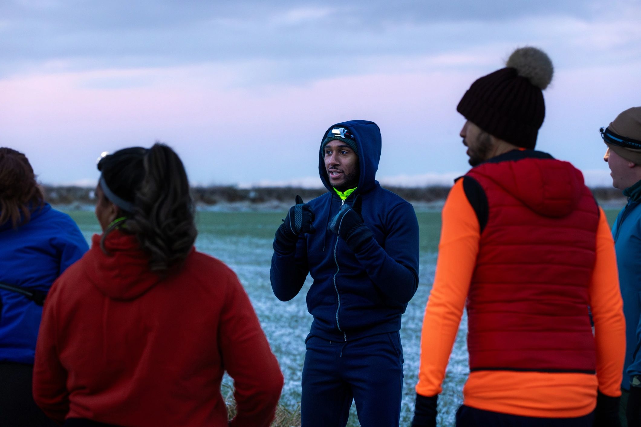 Running group gathering outdoors in sportswear before a session