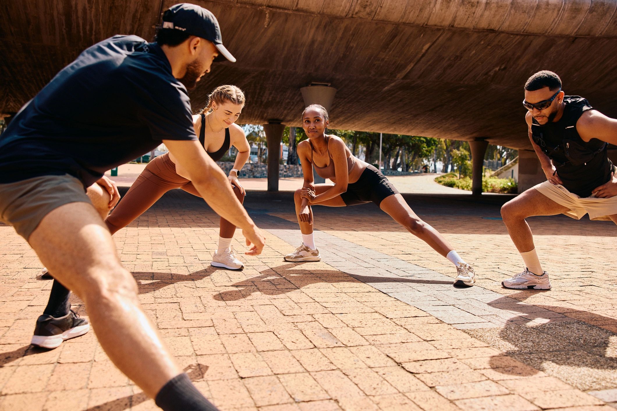 Runners stretching together during outdoor fitness training